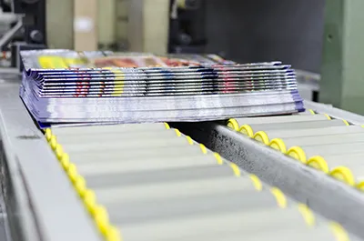 Printed magazines rolling off a printing press